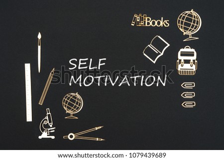 Concept back to school, text self motivation with school supplies chipboard miniatures placed on blackboard