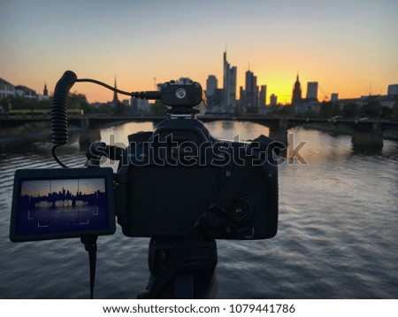 Photo camera in use for long exposure shot of Frankfurt skyline, Germany