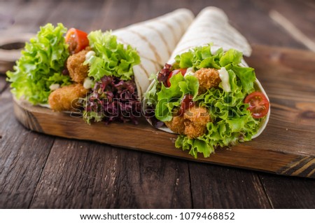 Grilled tortilla with chicken, mayo and tomato ketchuGrilled tortilla chicken, lettuce, homemade mayo and barbeque sauce, food photography
