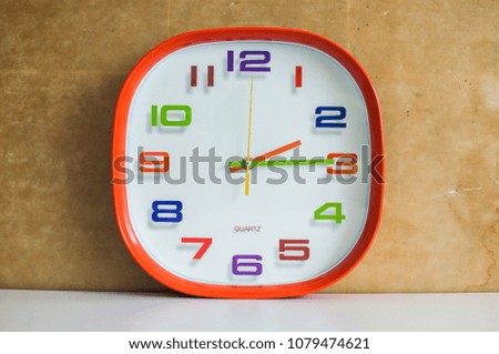 2 o'clock and 15 minutes over brown background
