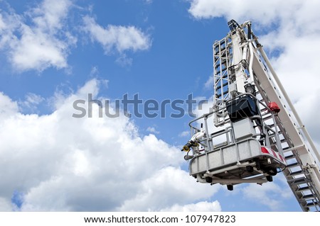 Hydraulic aerial fire platform on the sky background.