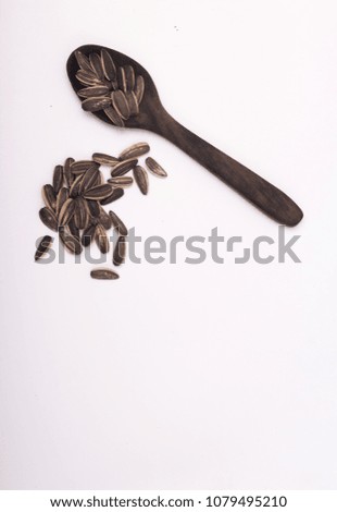 
a collection of sunflower seeds in the spoon for the background