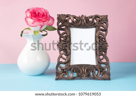 frame for text and flower rose in a white vase on a pink blue graphic background in pastel colors
layout in the Scandinavian style minimalism