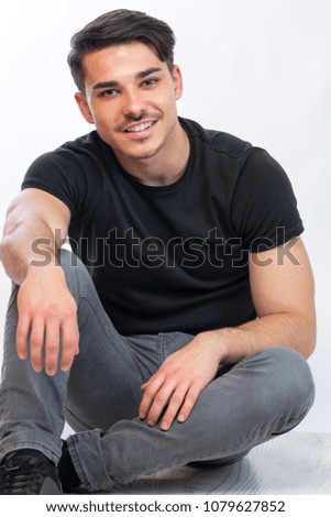 a young man with black tshirt agaist white background