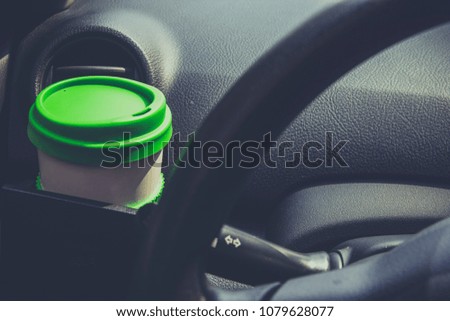 Cup coffee put on front console of a car while driving car