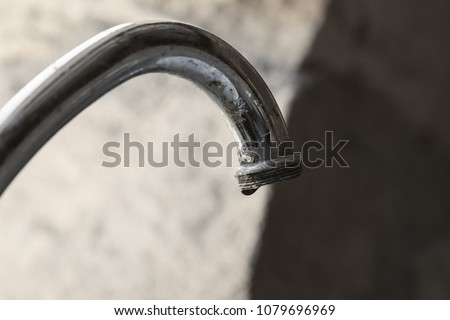 Water tap with peeling coating, close-up photo