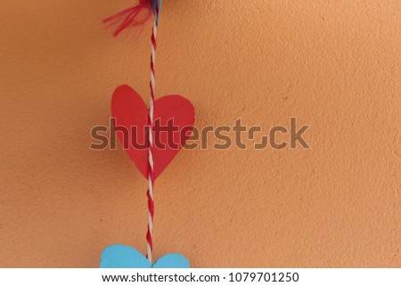 Paper cut into a heart shape with Old Rose color wall  as the background.