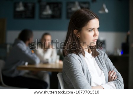 Offended frustrated millennial woman feeling upset suffering from loneliness having no friends or boyfriend sitting alone in cafe, sad social outcast or loner girl thinking of problem in public place Royalty-Free Stock Photo #1079701310