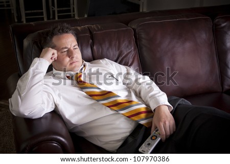 Lazy Male watching Television at home Royalty-Free Stock Photo #107970386