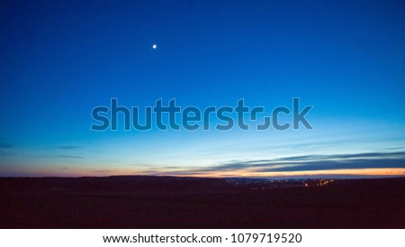 Late evening sky over village near fields. Rural landscape. Royalty-Free Stock Photo #1079719520