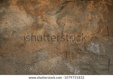 old plastered wall with stains and damage.