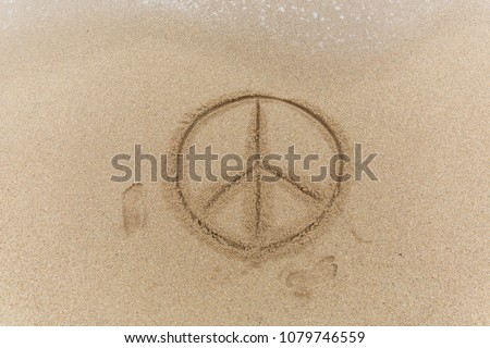 Peace sign on the sand