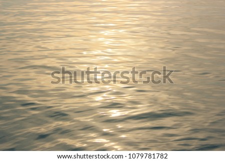 Beautiful sunlight on the sea, sunbeams on the water, sunset mild light. Natural background