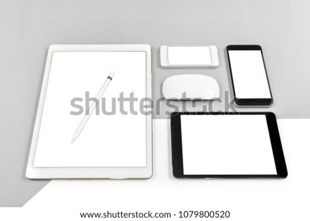 Office table with digital tablet, smartphone, mouse and pencil on isolated pure white background / Laptop and tablet mockup concept. (Monitor clipping path)(Selective Focus)