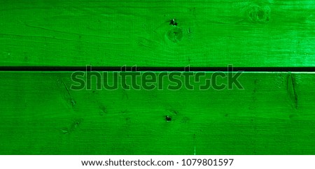 Green colored wall from a natural wood. Texture and background. Design for exteriors and interiors