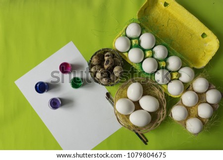 Easter background with white chicken Chicken and quail eggs in colored paper eco-friendly packaging with decorative sisal. Close-up photo, macro.  Food concept