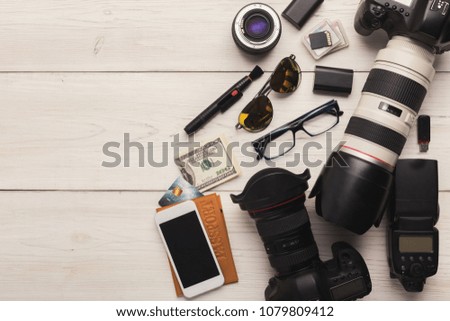 Photo equipment. Top view of diverse personal equipment for photographer or creative designer on white wooden table, copy space