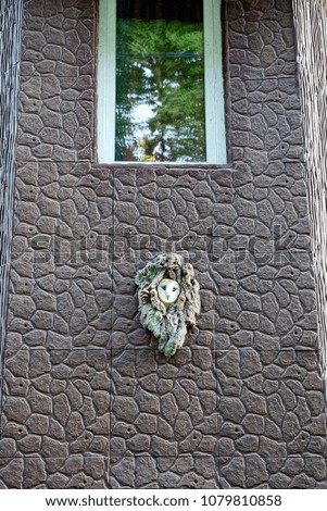 Brown house wall with window and decorative souvenir owl