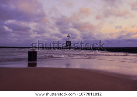 The colorful sky is rising on the shores of this Lake Michigan harbor on the beaches of Chicago.