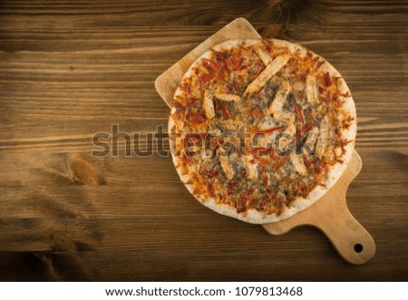 Whole Round Chicken Pizza on Natural Wooden Background Top View. Italian Food with Place for Text