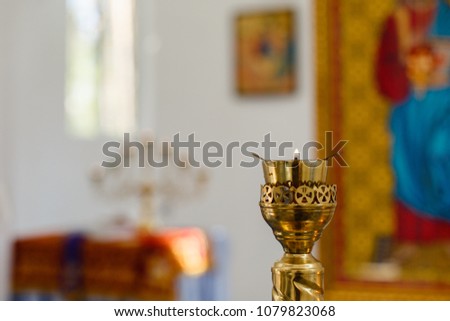 candles and lamp close-up. Interior Of Orthodox Church In Easter. baby christening. Ceremony a in Christian . bathing the into the baptismal font