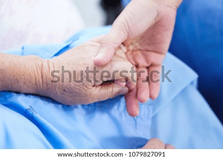 Holding hands Asian senior or elderly old lady woman patient with love, care, encourage and empathy at nursing hospital ward : healthy strong medical concept 
