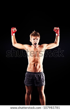 Portrait of a boxer champion enjoying his victory. Studio shot.