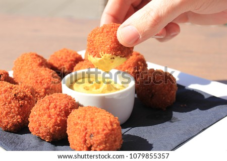 Dutch Bitterballen with mustard, warm stuffed fried meatballs, served in the Netherlands Royalty-Free Stock Photo #1079855357