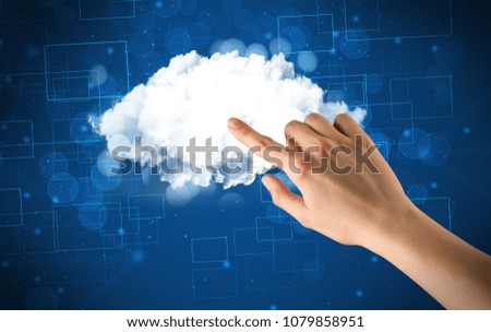 Female hand touching cloud with blue background 