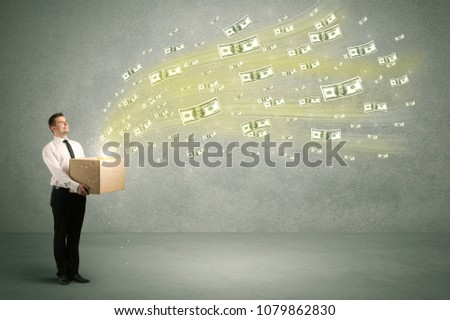 Successful young sales person making a lot of money concept illustrated with euro dollar bills flying out of a box held in his hand.