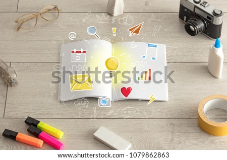 Open notebook on the floor with instruments nearby and icons symbols on it