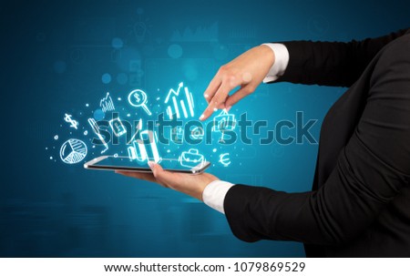 Elegant hand holding tablet with chalk drawn social media symbols above