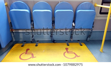 Facilities area for disabled people have folding seat and locking wheelchair in public transportation.