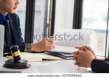 Justice lawyer meeting with contract papers and Judge gavel on tabel in courtroom. Attorney working in courtroom. Justice and law, attorney, court judge concept.
