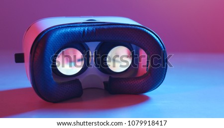 Holding virtual reality device with pink and blue light 