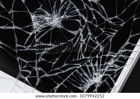 Broken display screen. Damaged smartphone glass. Closeup, dark background, selective focus