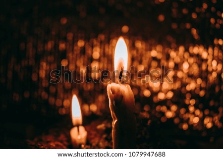 burning candle fire and bokeh background