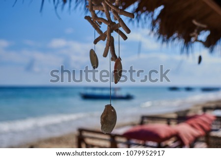 Wooden sunbed for relaxing on the paradise beach. Tropical recreational for vacation. Summer morning ocean view. Tropical sea resort beach serene scene. Relaxing atmosphere. Travel concept.