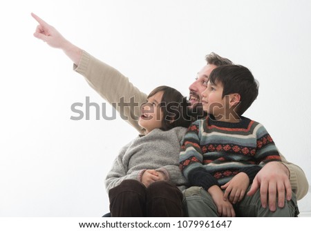 Happy Father with two sons Portrait Pointing at something