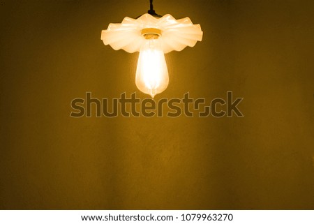 Close up white electric lamp with brown rock surface background. Electricity concept.