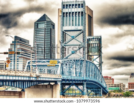Jacksonville skyline with bridge and buildings on a overcast day.