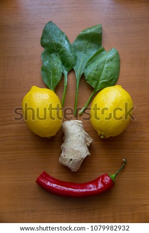 cheerful still life of lemons, spinach, pepper and ginger
