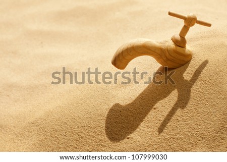 Global warming climate change faucet in the sand concept