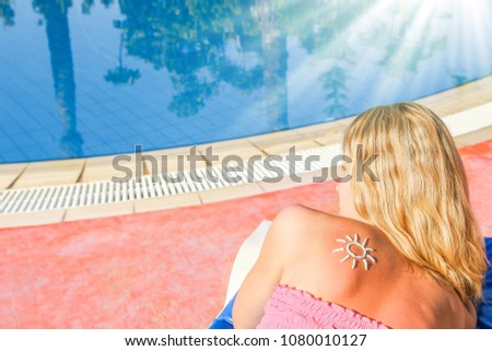 happy girl with the sun on her back at the pool in the nature