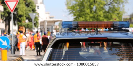 sirens of a police car with during a demonstration with people in the street