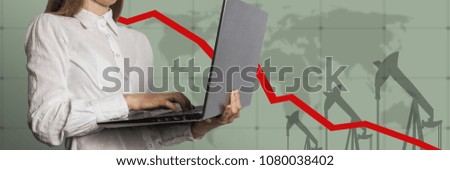 Girl with a laptop in hand and graph chart with the indicator on the oil price slide in the background. The concept of falling oil prices and stock trading.