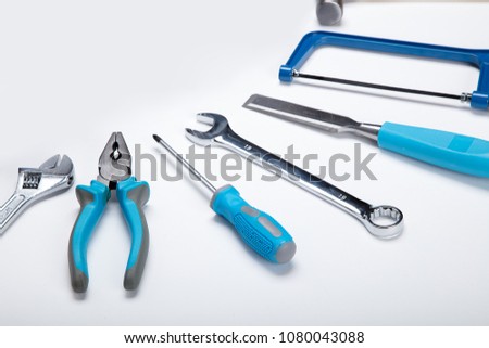 Set of tools isolated on white background. Hammer, screwdriver, brush, spanner pliers, measure tape