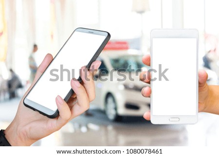 Mobile phone, blur image of car showroom as background.