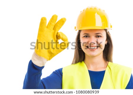 Young female constructor or contractor showing ok sign gesture and smiling as successful building concept isolated on white background