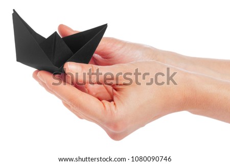 Paper ship in a female hand